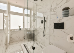 a white bathroom with a shower and a toilet - Sorglos Bauen GmbH - Sorglos Bauen GmbH