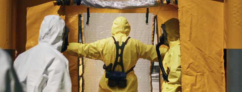 Members of biohazard teams in protective suits - Sorglos Bauen GmbH