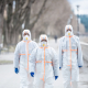People with protective suits walking outdoors, coronavirus concept. - Sorglos Bauen GmbH