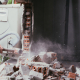 Unrecognizable builder using a sledgehammer breaking and smashing the wall fallen into debris - breaking wall and challenges concept - Sorglos Bauen GmbH