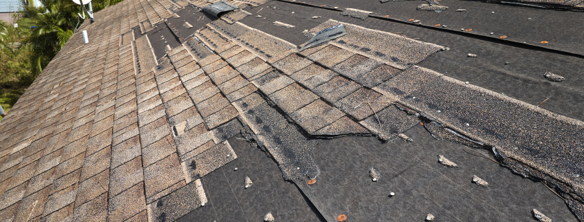 Wind damaged house roof with missing asphalt shingles after hurricane Ian in Florida. Repair of home rooftop concept - Sorglos Bauen GmbH