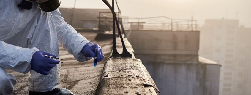 Worker scientist wearing protective coverall and gas mask doing ecological tests on the roof - Sorglos Bauen GmbH