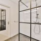 a white bathroom with a shower and a toilet - Sorglos Bauen GmbH